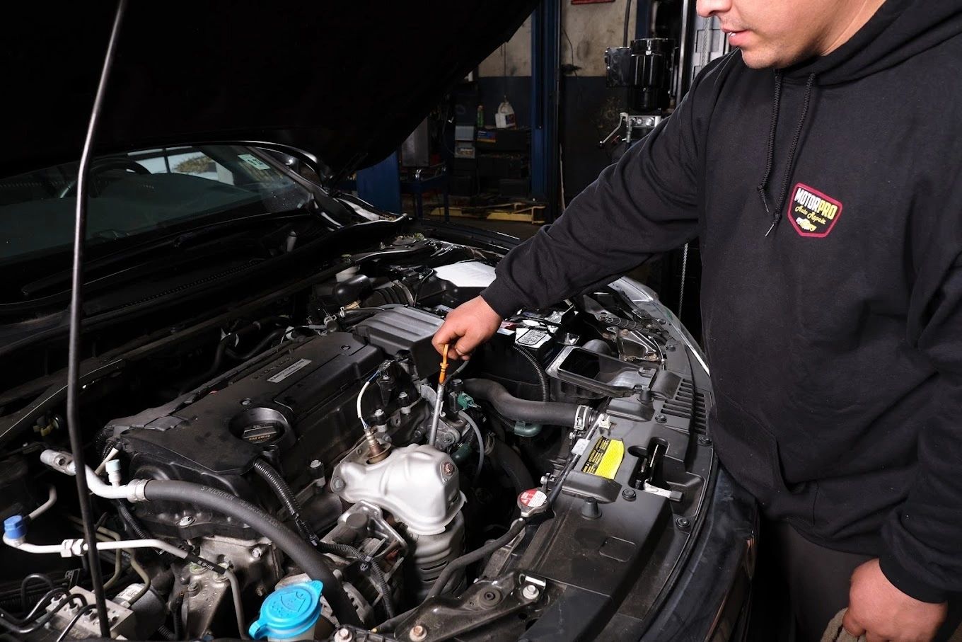 MotorPro technician checking the engine bay of a customer car in Dover, NJ